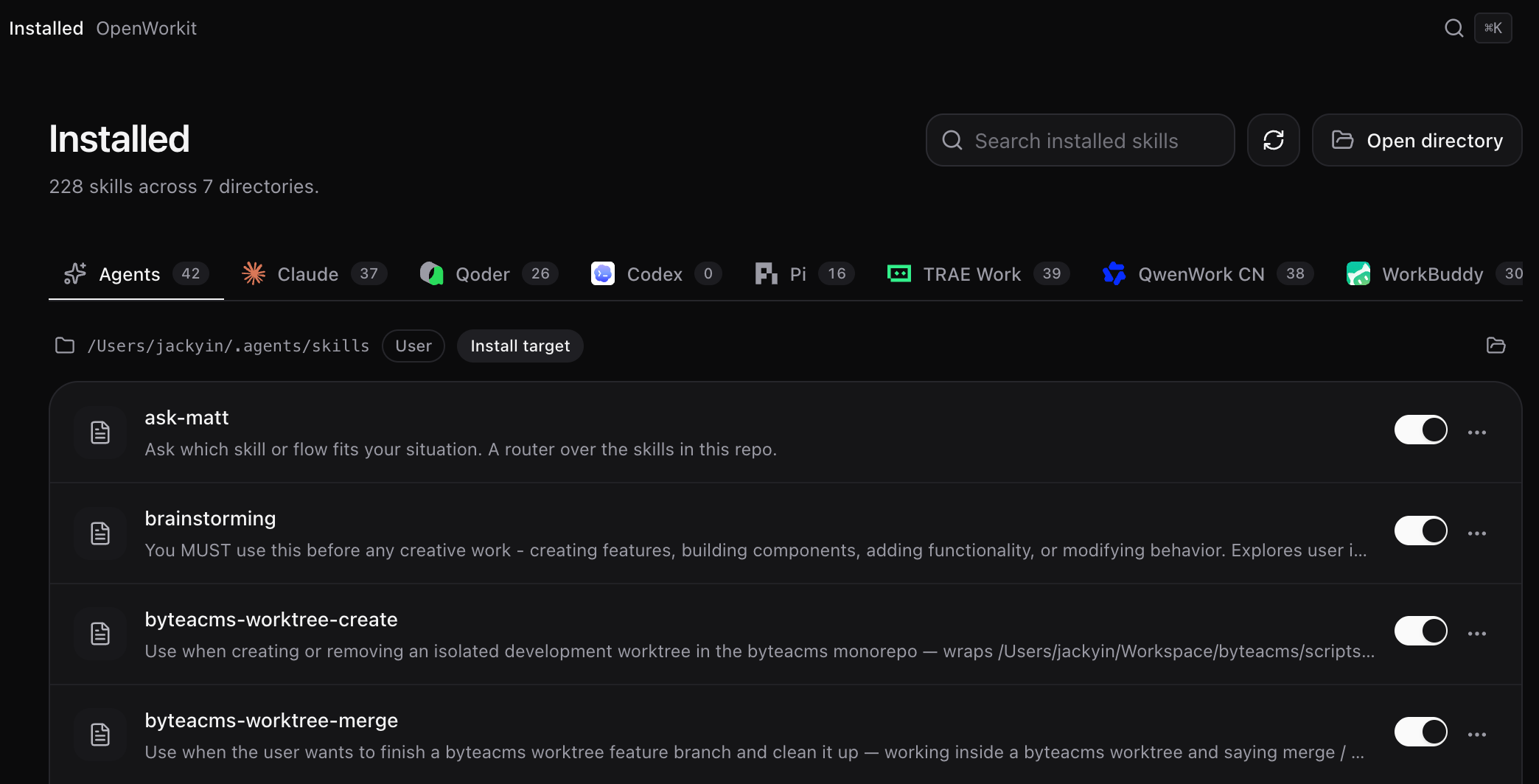 OpenWorkit 深色模式的「已安装」页:7 个目录共 228 个技能,顶部是各智能体的数量标签页,列表中每个技能带启用开关。